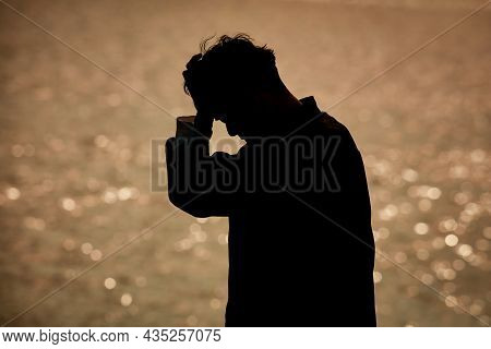 Image Of A Man Holding His Head