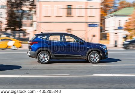 Blue Kia Seltos Fast Moving On A City Road. Compact Suv Car On Street In Motion. Overspeed In City C