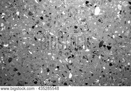 Cement Plate With Small Gravel Stones In Black And White. Abstract Background And Texture For Design