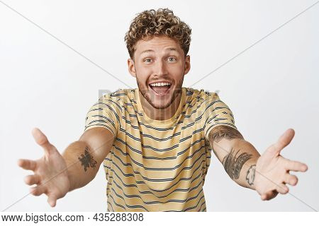 Happy Young Man Strecthing Out Hands To Hold Someone, Waiting For Hug, Receiving Something In His Ar