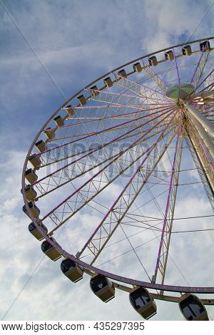 Worms Eye View Of A Ferris Wheel Stretching Into The Sky