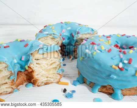 Blue Cronuts On A White Wooden Background. High Quality Photo