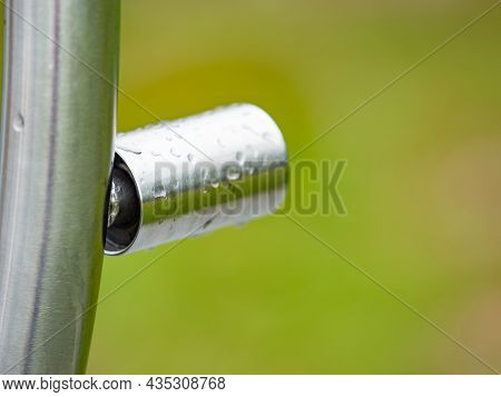 Detail Of Stainles Steel Construction With Rain Drops.  Gray White Sky Metal