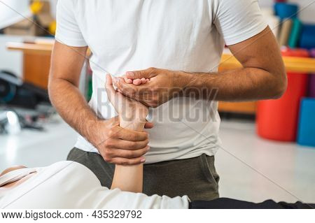 Woman During A Physiotherapy Treatment. Rehabilitation Therapy For Injured Elbow And Hand Wrist.