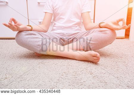 Unrecognizable Meditating Teenage Boy Sitting On A Carpet At Home, Spiritual Yoga Buddhism Practics,