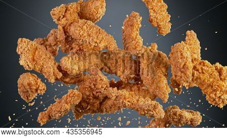Freeze motion shot of flying tasty fried chicken wings or strips
