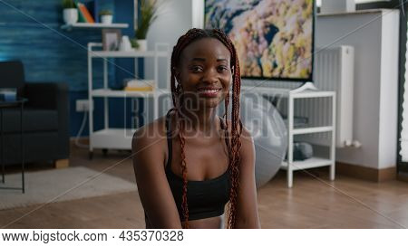 Portrait Of Fit Black Woman Looking Into Camera While Sitting In Lotus Position On Yoga Map Working 