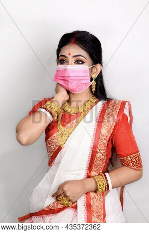 Portrait Of Pretty Young Indian Girl Wearing Traditional Indian Saree, Gold Jewellery, Bangles And M