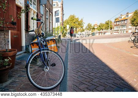 Haarlem, The Netherlands - Aug 24, 2019: Peugeot Bike With Postnl Postal Bike Carriage Parked On The
