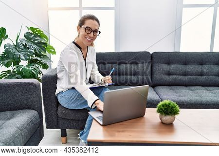 Young hispanic woman having teleconsultation psychology session at psychology clinic
