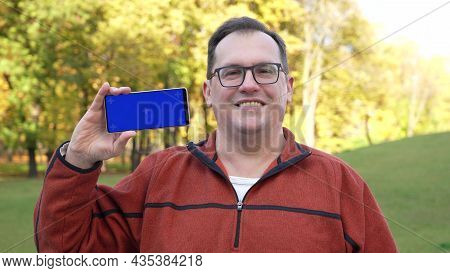 Man Holdingsmartphone With Blue Screen And Chroma Key.