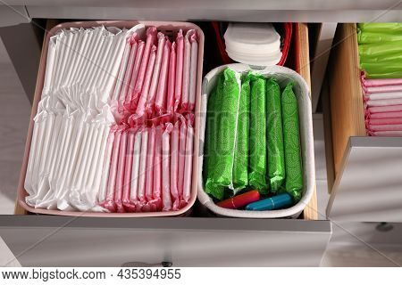 Open Cabinet Drawers With Menstrual Pads, Tampons And Pantyliners Indoors, Above View