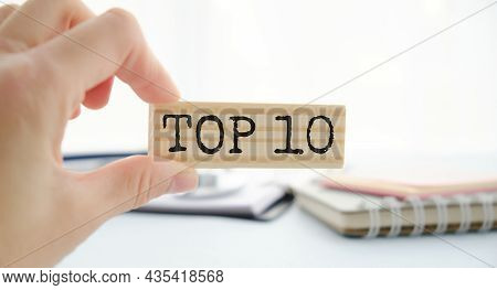Top 10 Sign Made Of Wooden Dices On A Table I A Bright Environment With Blue Colors