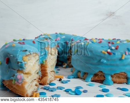 Blue Cronuts On A White Wooden Background. High Quality Photo