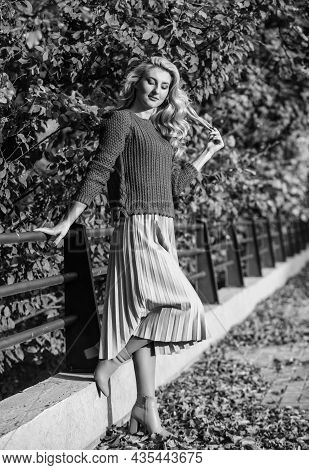 Cute Smiling Woman. Sunny Day With Leaves. Fall Fashion Season. Girl In Corrugated Skirt And Sweater