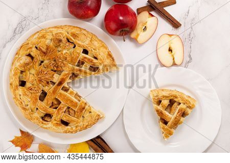 Autumn Apple Pie And A Slice Of Pie. Apple Pie, Cinnamon, Apples And Autumn Leaves. Top View