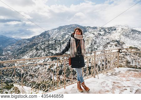 Young Woman Standing At Mountain Top Observation Deck Over Vouraikos Gorge. Mega Spileon Monastery T