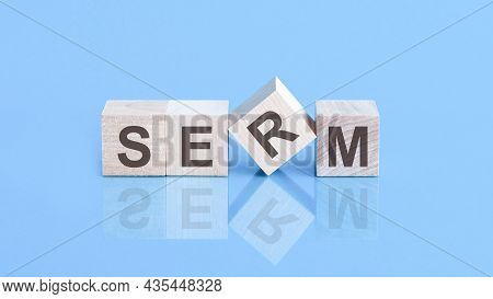 Serm Word Is Made Of Wooden Cubes Lying On The Blue Table, Concept
