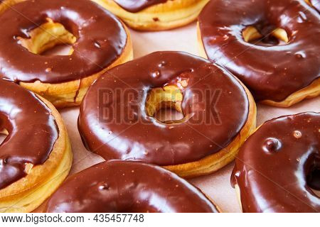 Delicious Tray Of Yeast Donuts With Chocolate Sauce On Top