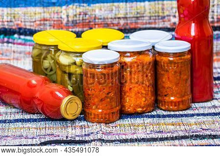 Glass Jars With Pickled Red Bell Peppers And Pickled Cucumbers (pickles) Isolated. Jars With Variety