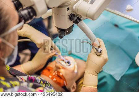 Dental Treatment With A Microscope. Woman Having Teeth Examined At Dentists. Appointment At The Dent