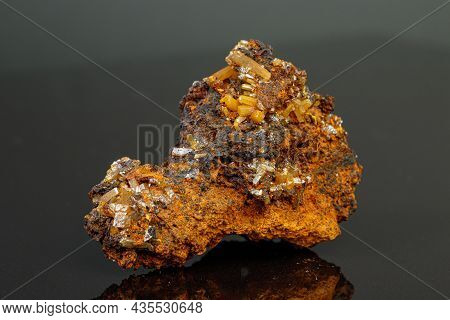 Macro Mineral Wulfenite Stone On A Black Background Close-up