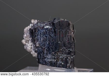 Macro Mineral Acanthite Stone On A Black Background Close-up