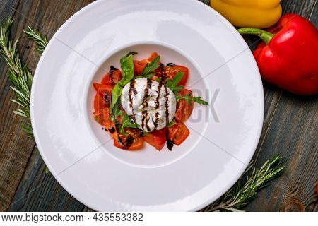 Salad With Buratta Cheese And Tomatoes On Plate