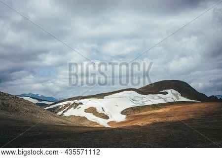 Sunny Mountain Desert Relief With Glacier In Sunlight Under Low Cloudy Sky. Scenic Highlands Landsca