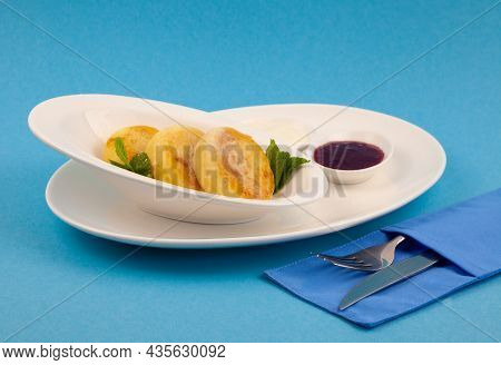 A Portion Of Three Round Curd Cheese Pancakes On A White Plate. Healthy Breakfast. Blue Background