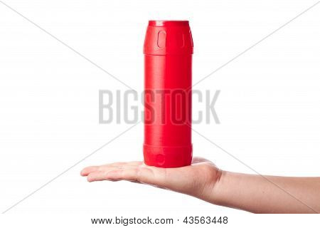 Red Bottle With Cleaning Powder In Hand Isolated On White