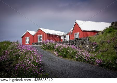 Hafnarfjordur, Iceland - July 17, 2021:
Three Traditional Red Houses With White Roofs  In Icelandic 
