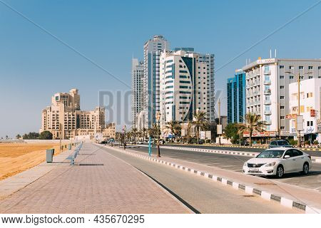 Ajman, United Arab Emirates - May 17, 2021: Nissan Car Parked In Street. Building Of Bahi Ajman Pala