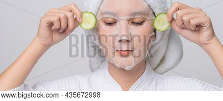 Asian Woman With Cucumber Slice For Anti Wrinkles And Treatment Eye Dark Circles. Treatment Eye Dark