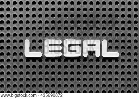 White Alphabet Letter In Word Legal On Black Pegboard Background