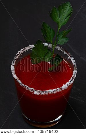 Close-up Tomato Juice With Celery, Spices, Salt And Ice In Glass With Copy Space. Bloody Mary Cockta