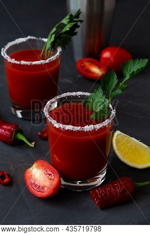 Two Glasses With Tomato Juice With Pepper, Spices, Salt And Ice In Glass With Copy Space. Bloody Mar