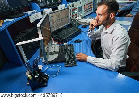 Network Administrator Speaking On Phone While Administering Data Center Servers