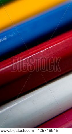 Vertical Macro Shot Of The Bodies Of A Variety Of Wooden Color Pencils Arranged In Layers