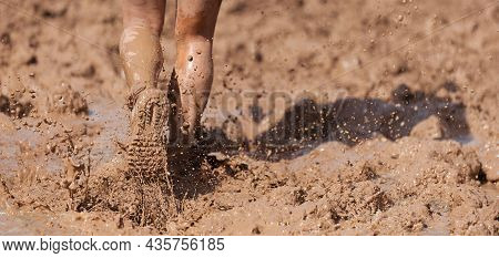 Mud Race Runners Detail Of The Legs, Muddy Running Shoes A Run In The Mud