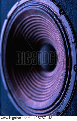 Close-up Of Speaker Membrane On Black Background With Colored Lighting.