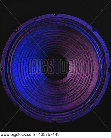 Close-up Of Speaker Membrane On Black Background With Colored Lighting.