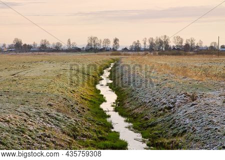Irrigation Ditch Near A Small Village In Autumn