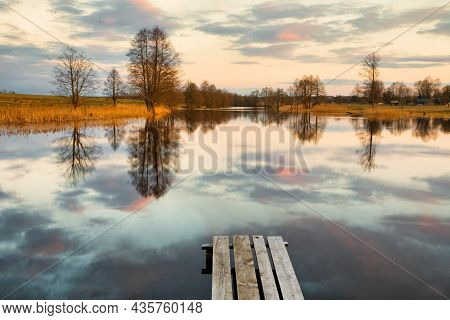 Footbridge On The Lake At Sunset In Autumn