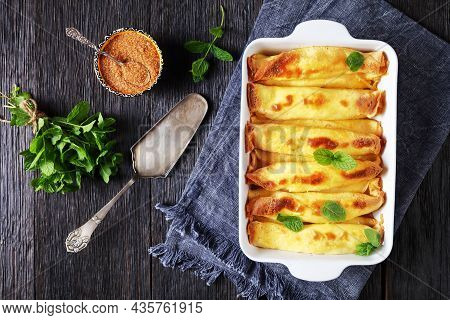Blintz, Rolled Filled With Sweetened Cottage Cheese Pancakes Or Crepes In A Baking Dish On A Wooden 