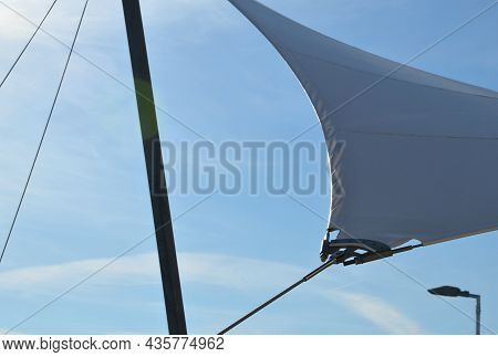 White Tarpaulin Taut, Shading From The Sun And Rain Over The Terrace Of The Restaurant, On The Playg