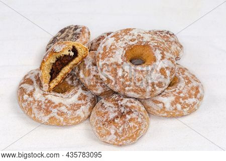 Ring Shaped Spice Cookies And Thick Round Cookies With Jam Filling Glazed With Icing Sugar On The Wh