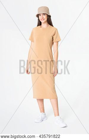 Woman in beige t-shirt dress and bucket hat casual wear apparel