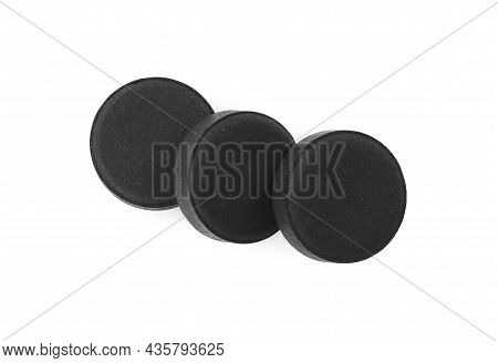 Activated Charcoal Pills On White Background, Top View. Potent Sorbent