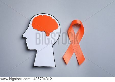 Human Head Cutout, Brain And Orange Ribbon On Grey Background, Flat Lay. Multiple Sclerosis Concept